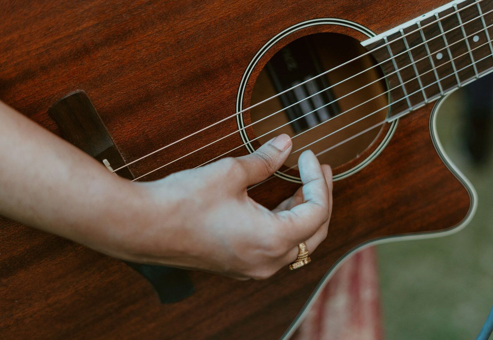 Photo by Vidit Goswami a person holding a guitar in their hand