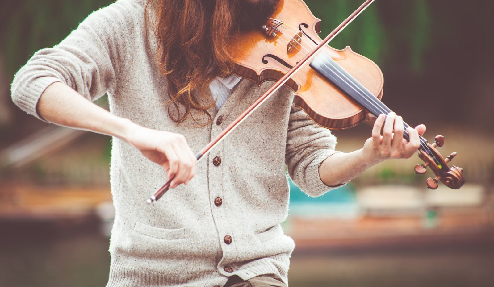 Photo by Clem Onojeghuo person playing brown violin